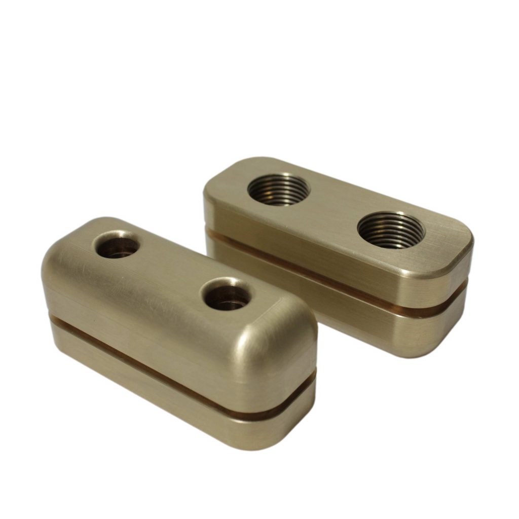 A Pair of CNC Milled Brass Components with undercut slot and threaded holes manufactured in house at Parallel Precision